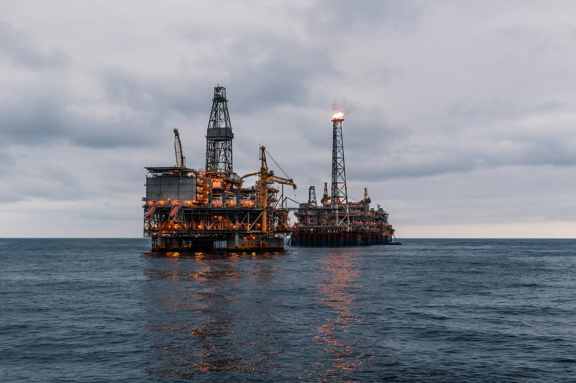 FPSO tanker vessel near Oil Rig platform. Offshore oil and gas industry